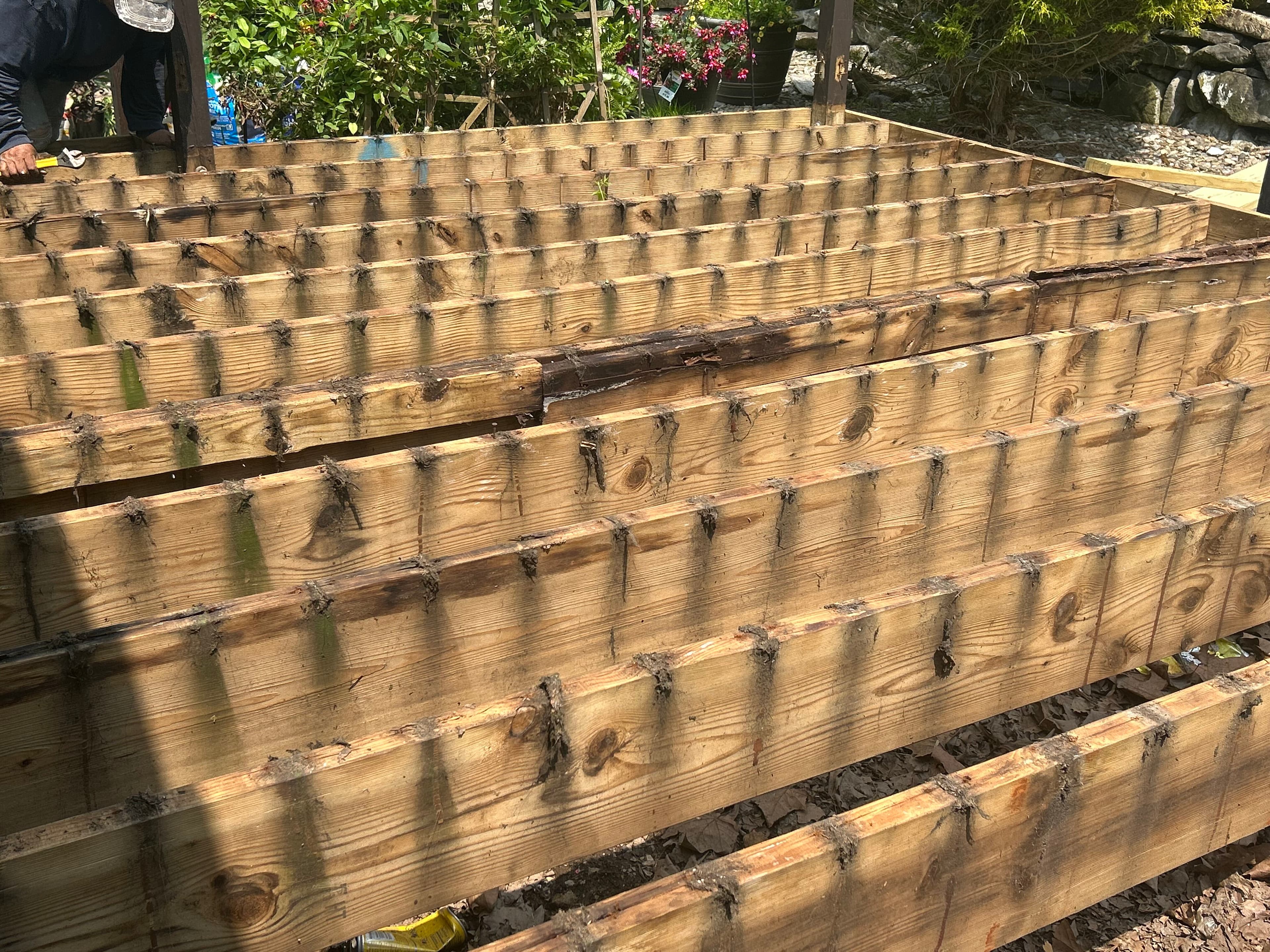 Wood retaining wall and deck support