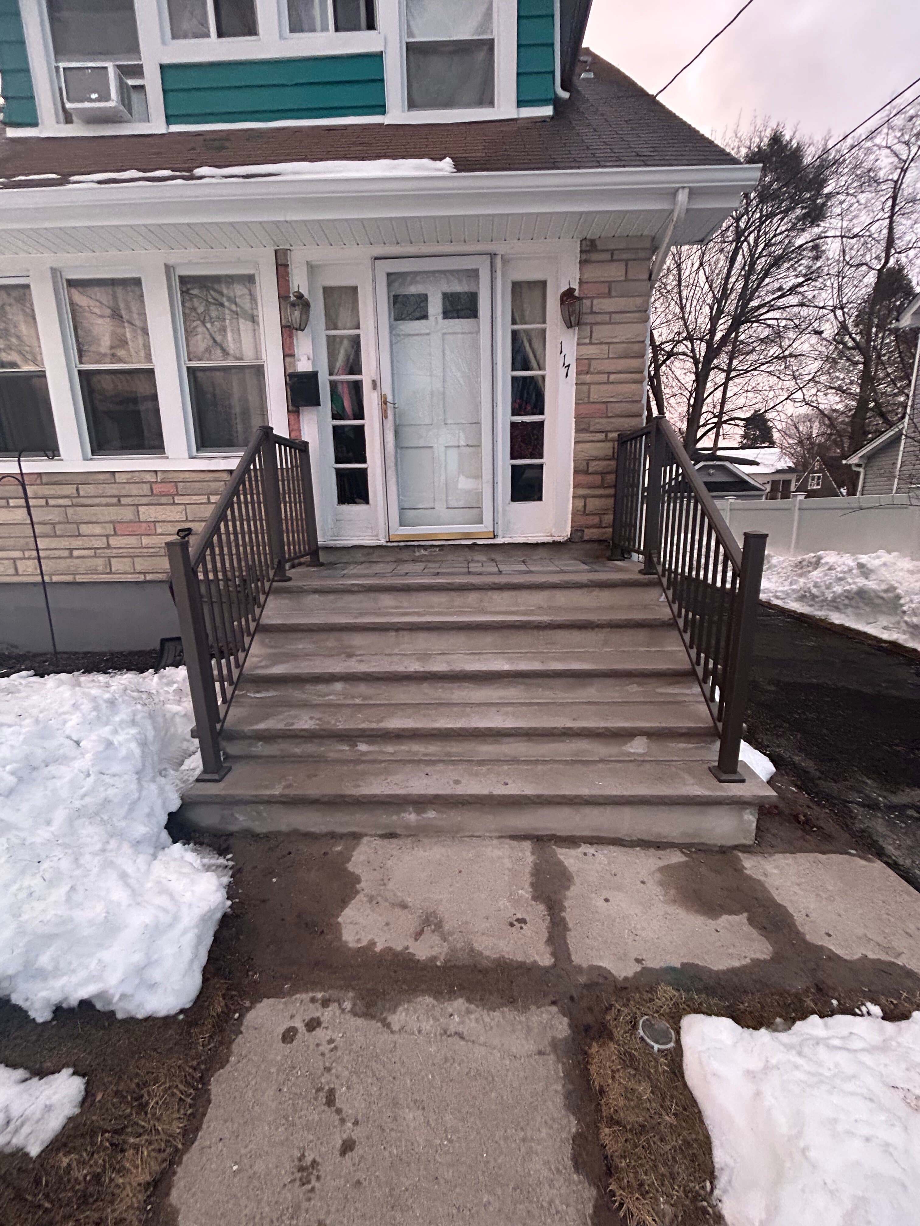 Front entry steps with metal railings